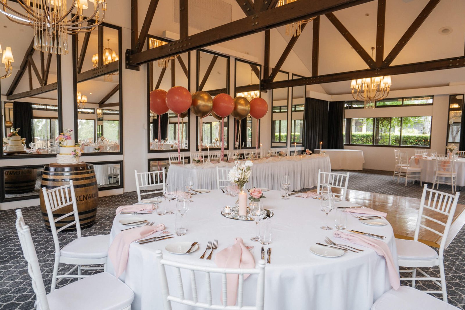 Chandeliers and timber trusses over round tables in the Barrington Room