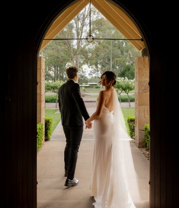 A couple walking out through the chapel arch
