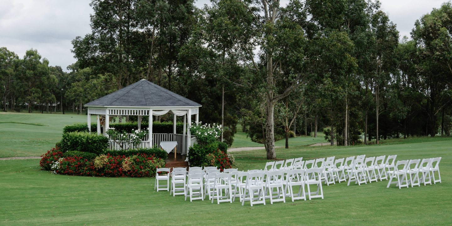 The Summerhouse Rotunda with white ceremony chairs on the Fairway Lawn