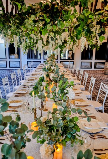 A long table with hanging greenery